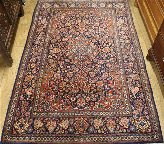 An Isfahan red ground medallion rug 202cm x 133cm